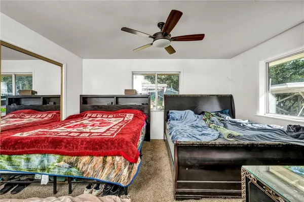 a bedroom with a bed and window