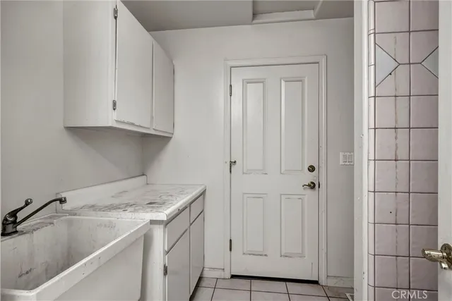 a view of a kitchen with white cabinets and sink