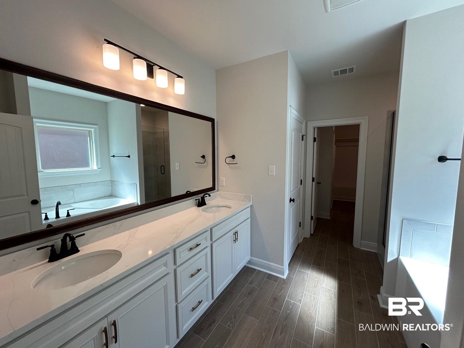 872 Sumter Loop Foley, AL 36535 - Photo 6 of 18 Bathroom featuring vanity, separate shower and tub, and wood-type flooring