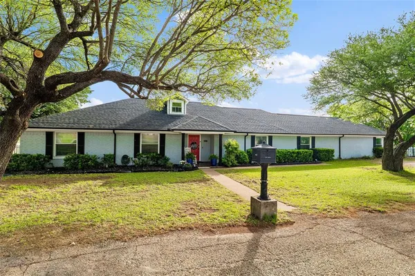 a living room with furniture or chandelier and a wooden floor