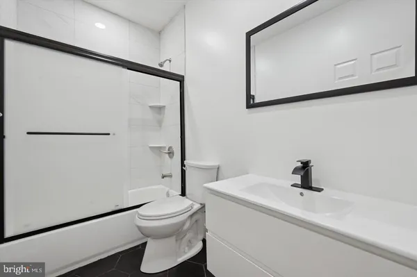 a bathroom with a toilet a sink and a shower