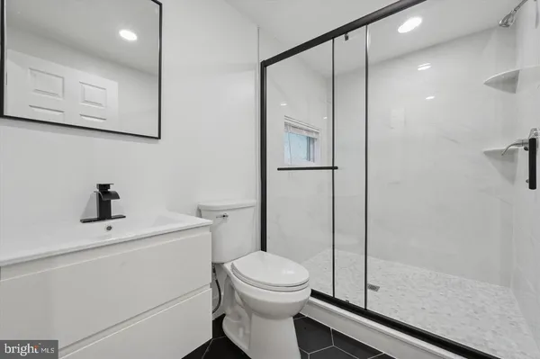 a bathroom with a toilet a sink and a shower