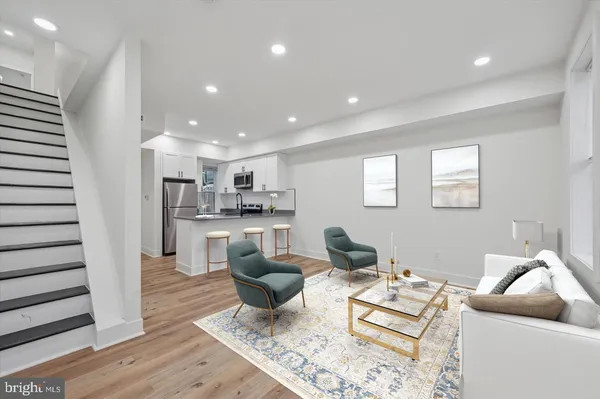 a living room with kitchen island furniture and a wooden floor