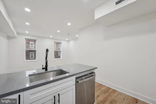 a kitchen with a sink and cabinets