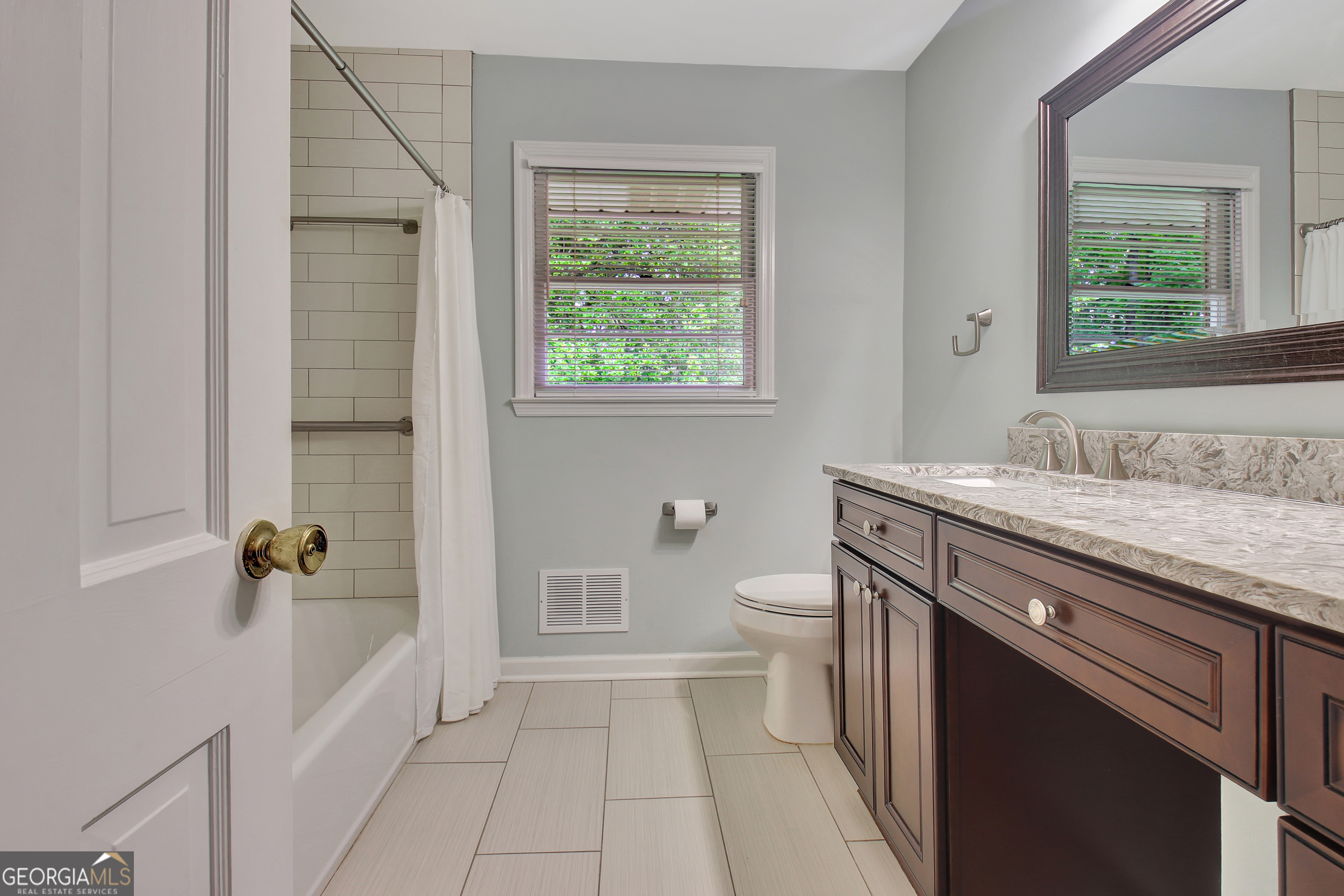 717 Tyrone Road Tyrone, GA 30290 - Photo 22 of 58 a spacious bathroom with a granite countertop sink a toilet and shower