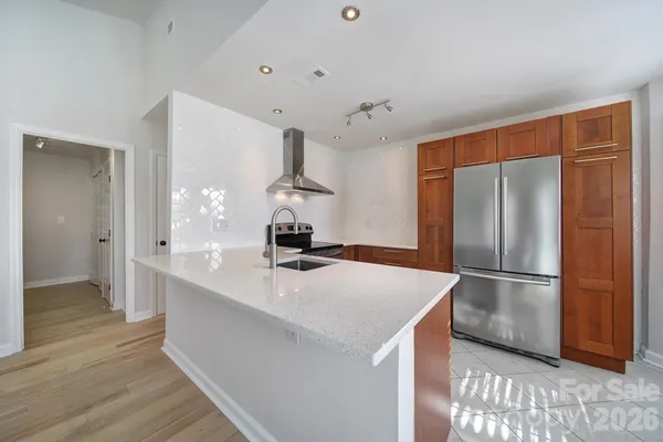 a kitchen with stainless steel appliances a refrigerator and a sink