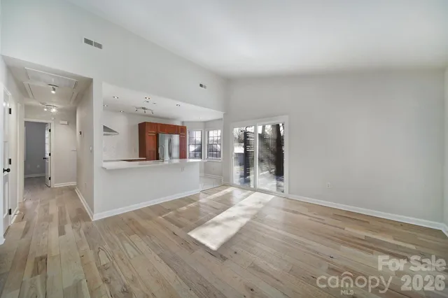 a view of empty room with wooden floor