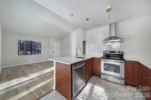 a kitchen with stainless steel appliances granite countertop a stove and a sink