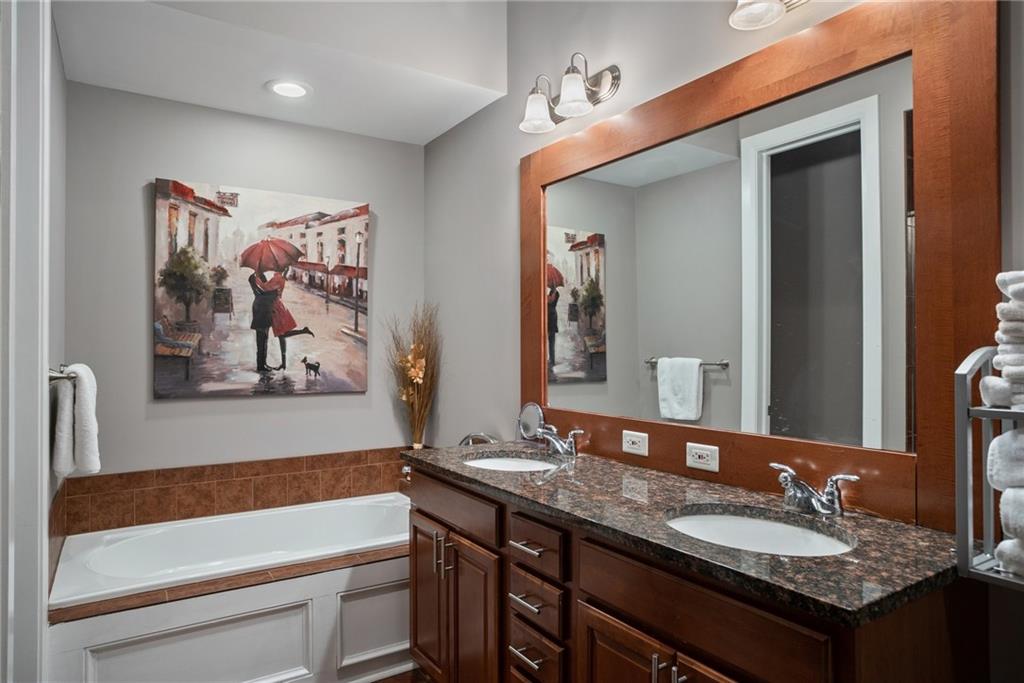 301 Fifth Avenue, Unit 511 Pittsburgh, PA 15222 - Photo 15 of 33 a bathroom with a granite countertop sink and a mirror