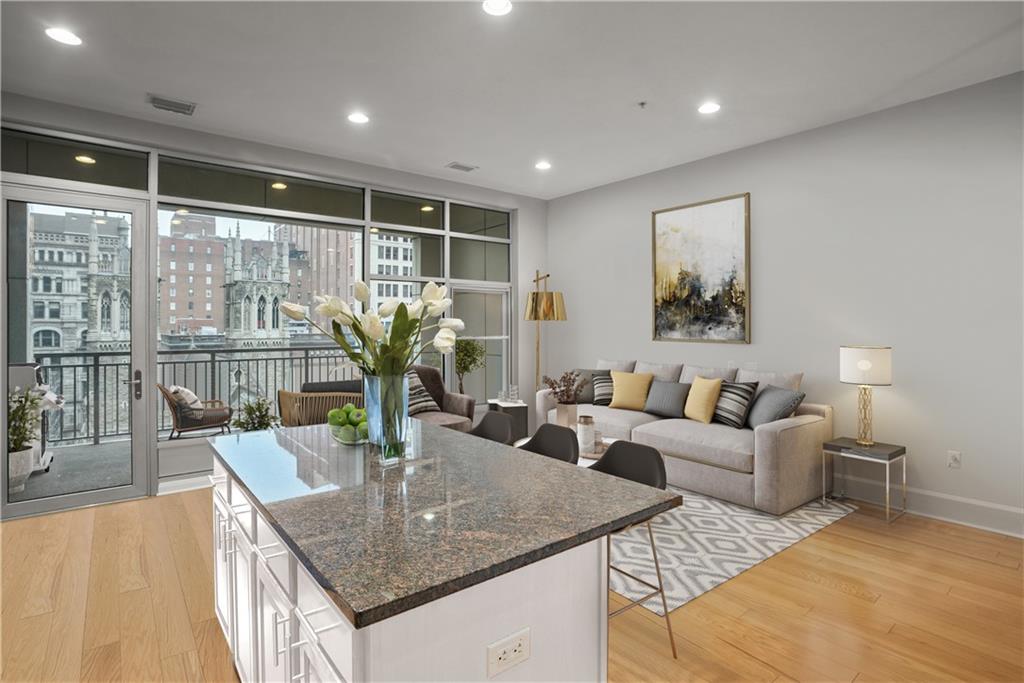 301 Fifth Avenue, Unit 511 Pittsburgh, PA 15222 - Photo 6 of 33 a living room with stainless steel appliances granite countertop a table and chairs
