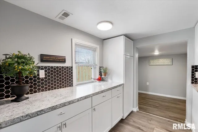 a kitchen with a refrigerator and a sink