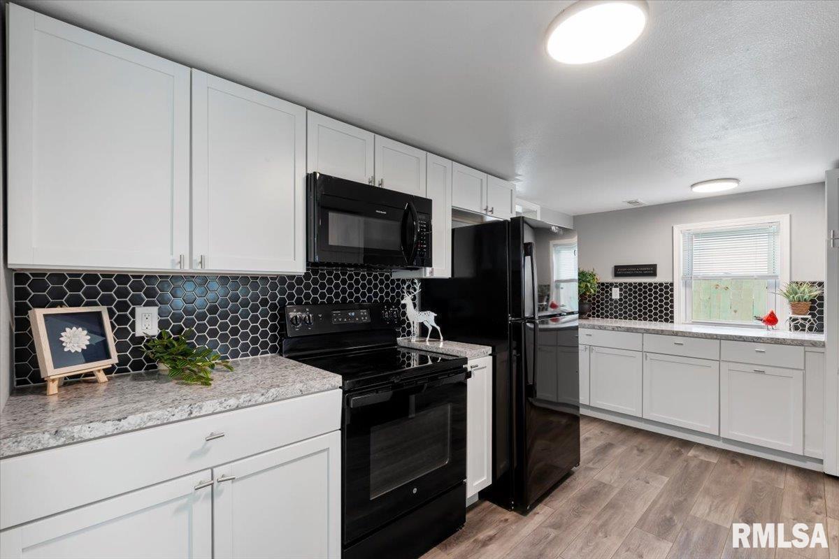 321 2nd Avenue East Milan, IL 61264 - Photo 16 of 33 a kitchen with a sink stove and refrigerator