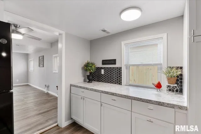 a view of a kitchen with refrigerator and an oven