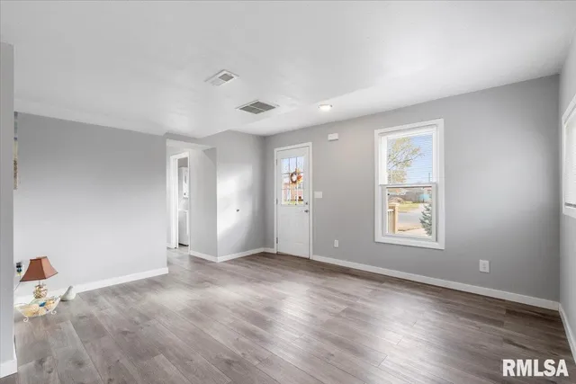 a view of an entryway with wooden floor