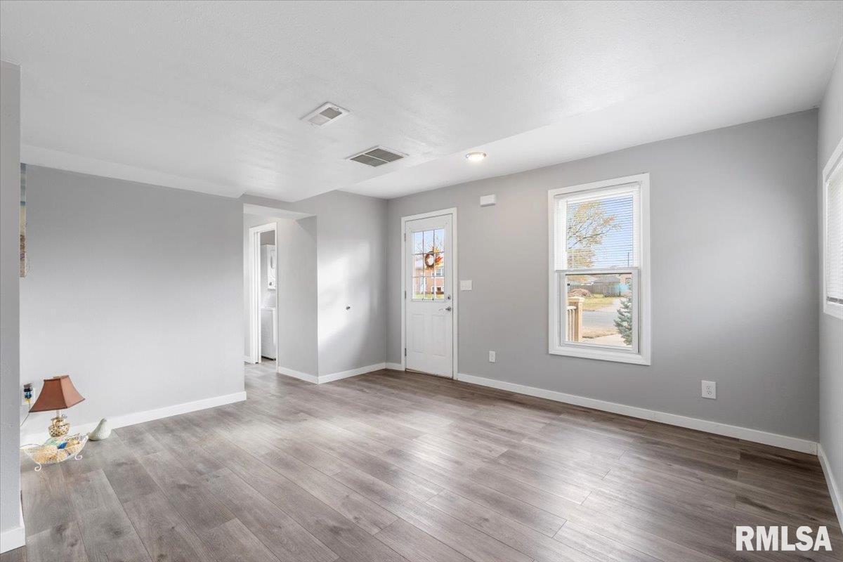 321 2nd Avenue East Milan, IL 61264 - Photo 10 of 33 an empty room with wooden floor and windows