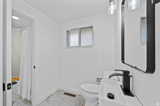 2267 West 4350th Street South Roy, UT 84067 - Photo 15 of 32 Bathroom featuring curtained shower and light marble finish flooring