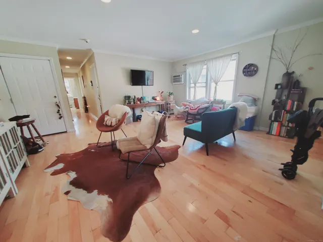 a living room with furniture or couch and a flat screen tv