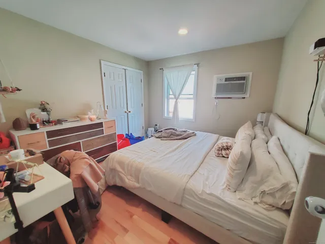 a bedroom with two beds and a desk