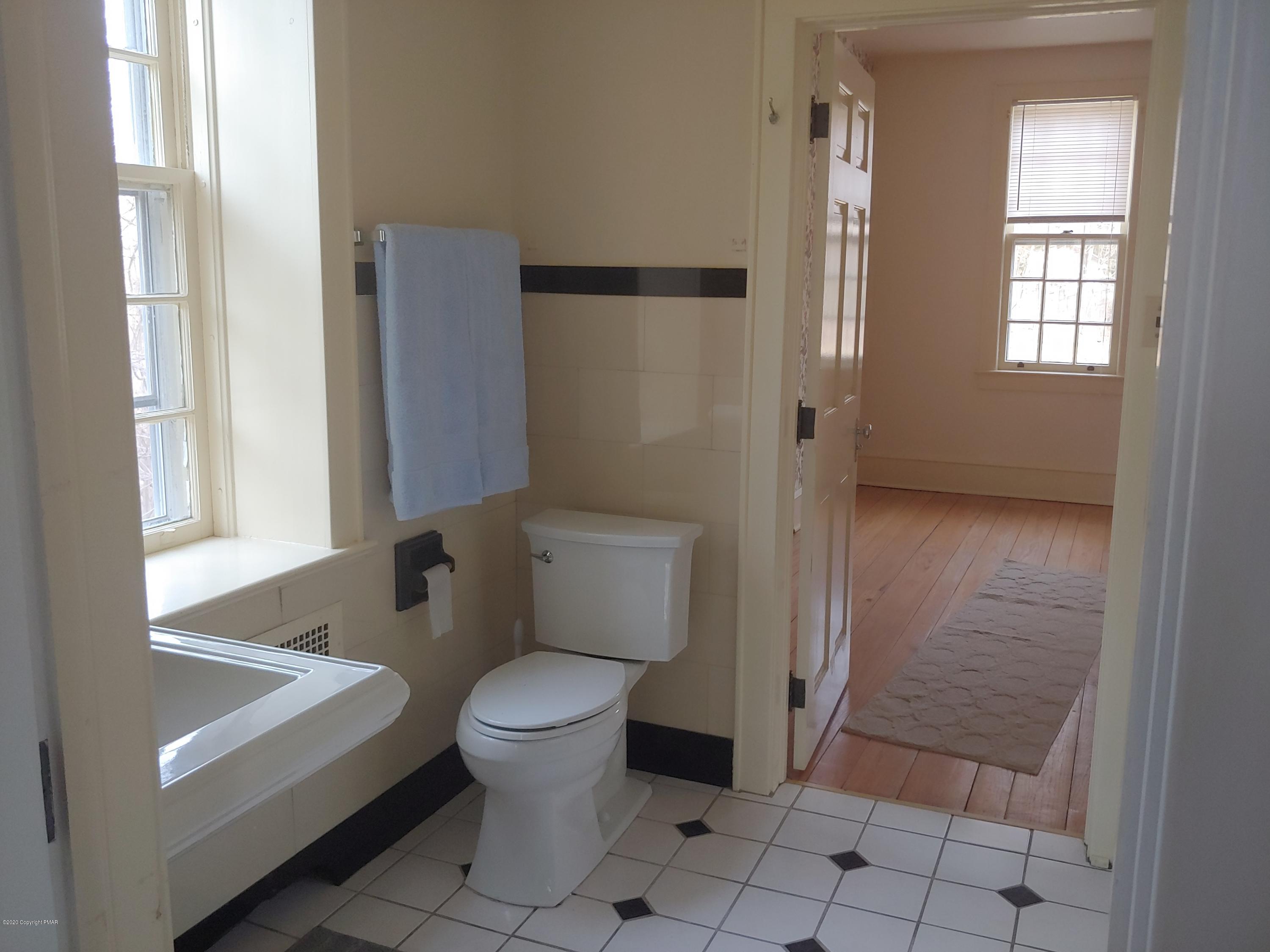 476 Laurel Pine Road Cresco, PA 18326 - Photo 26 of 45 a bathroom with a sink a toilet a window and shower