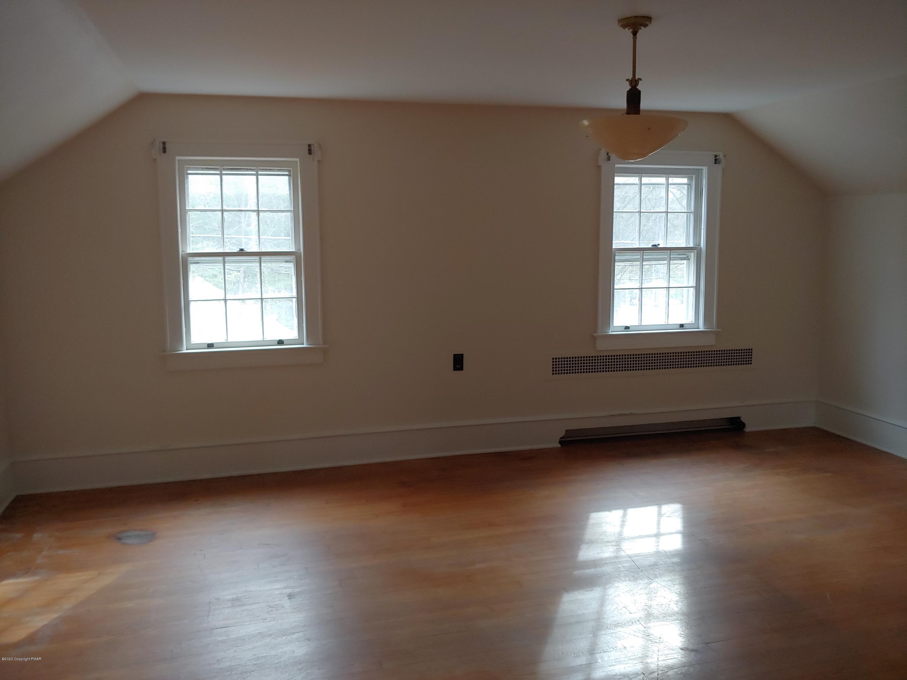 476 Laurel Pine Road Cresco, PA 18326 - Photo 30 of 45 an empty room with wooden floor and windows