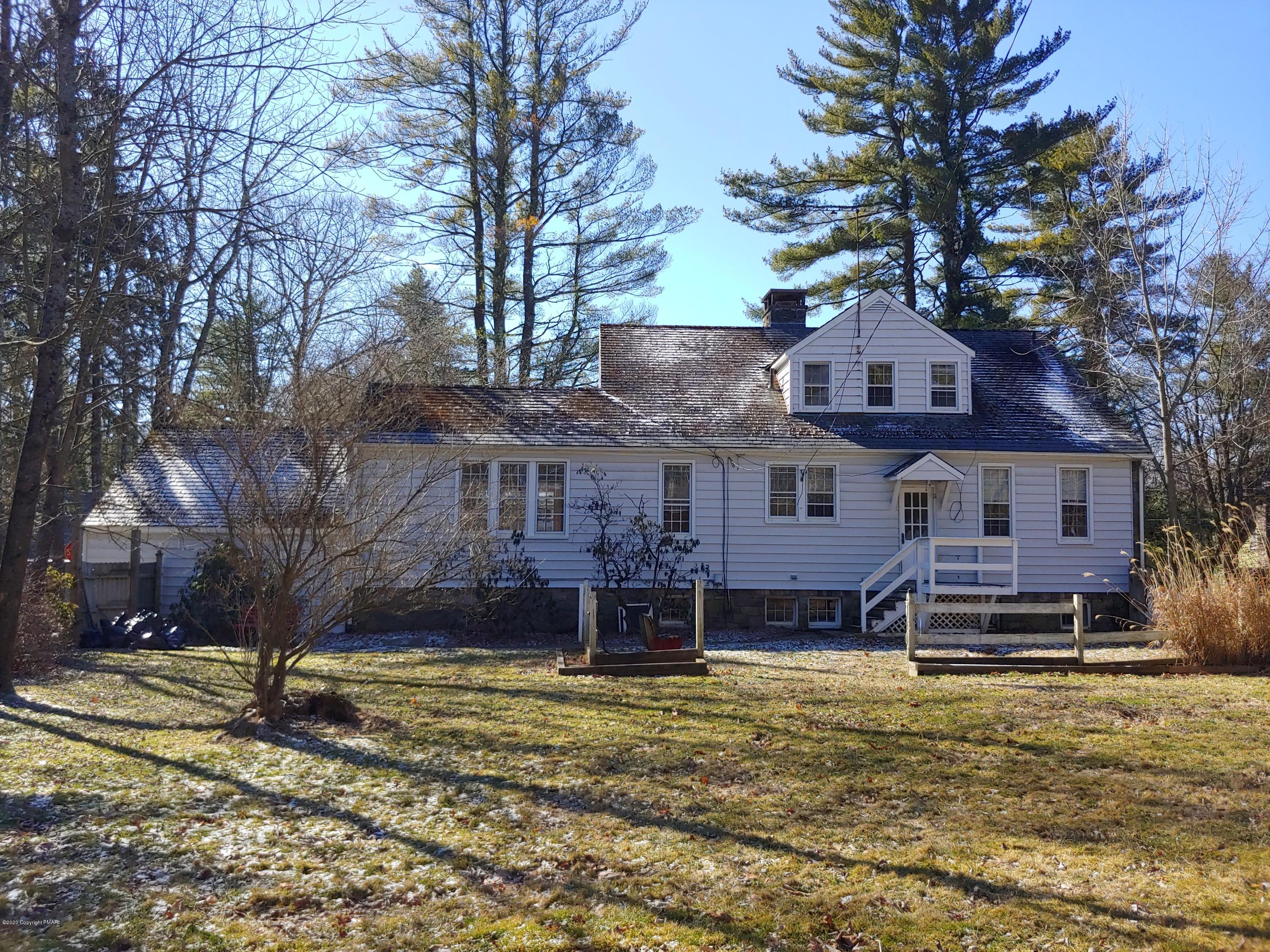 476 Laurel Pine Road Cresco, PA 18326 - Photo 3 of 45 a front view of a house with a yard covered with trees