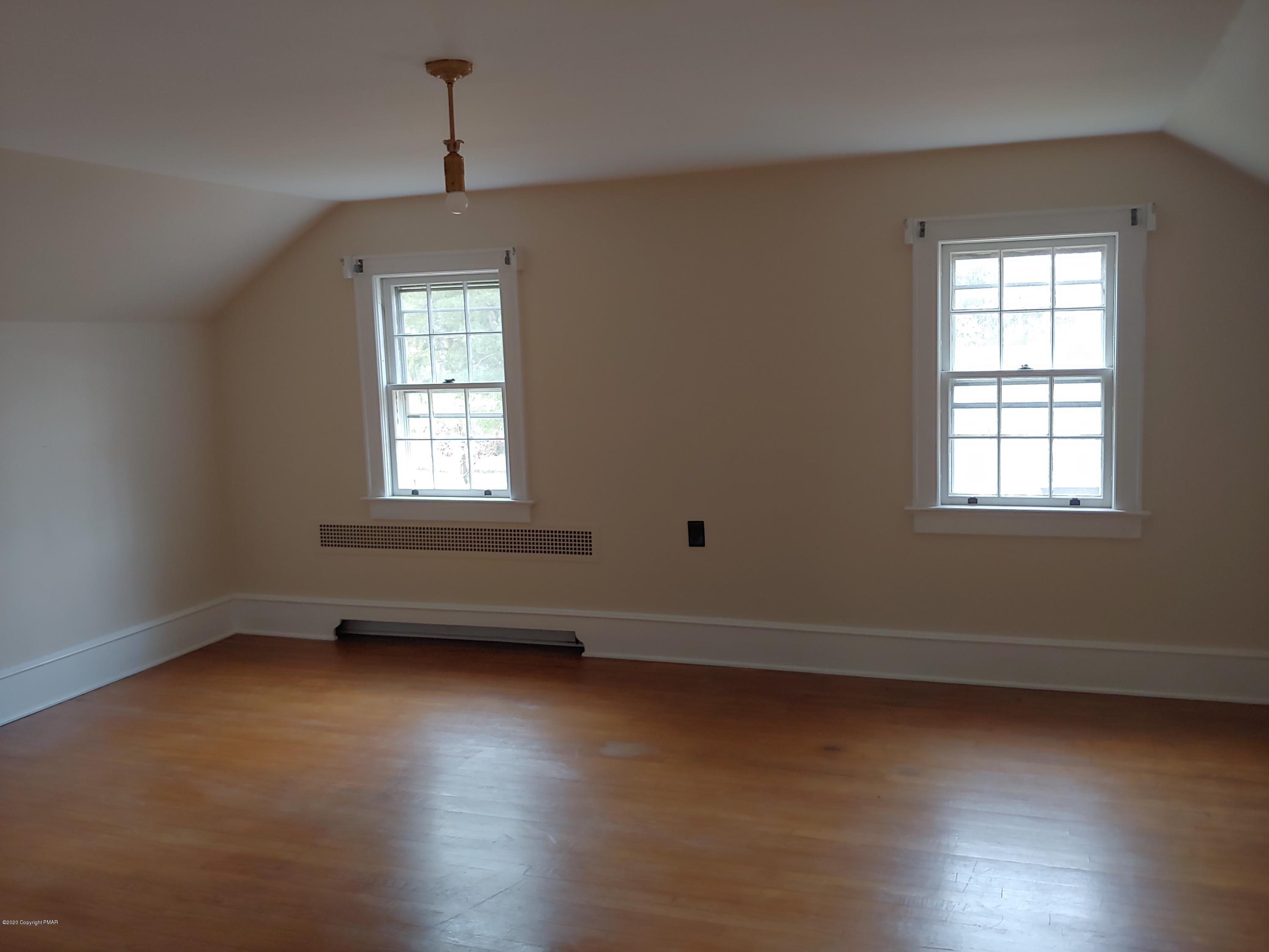 476 Laurel Pine Road Cresco, PA 18326 - Photo 31 of 45 an empty room with wooden floor and windows