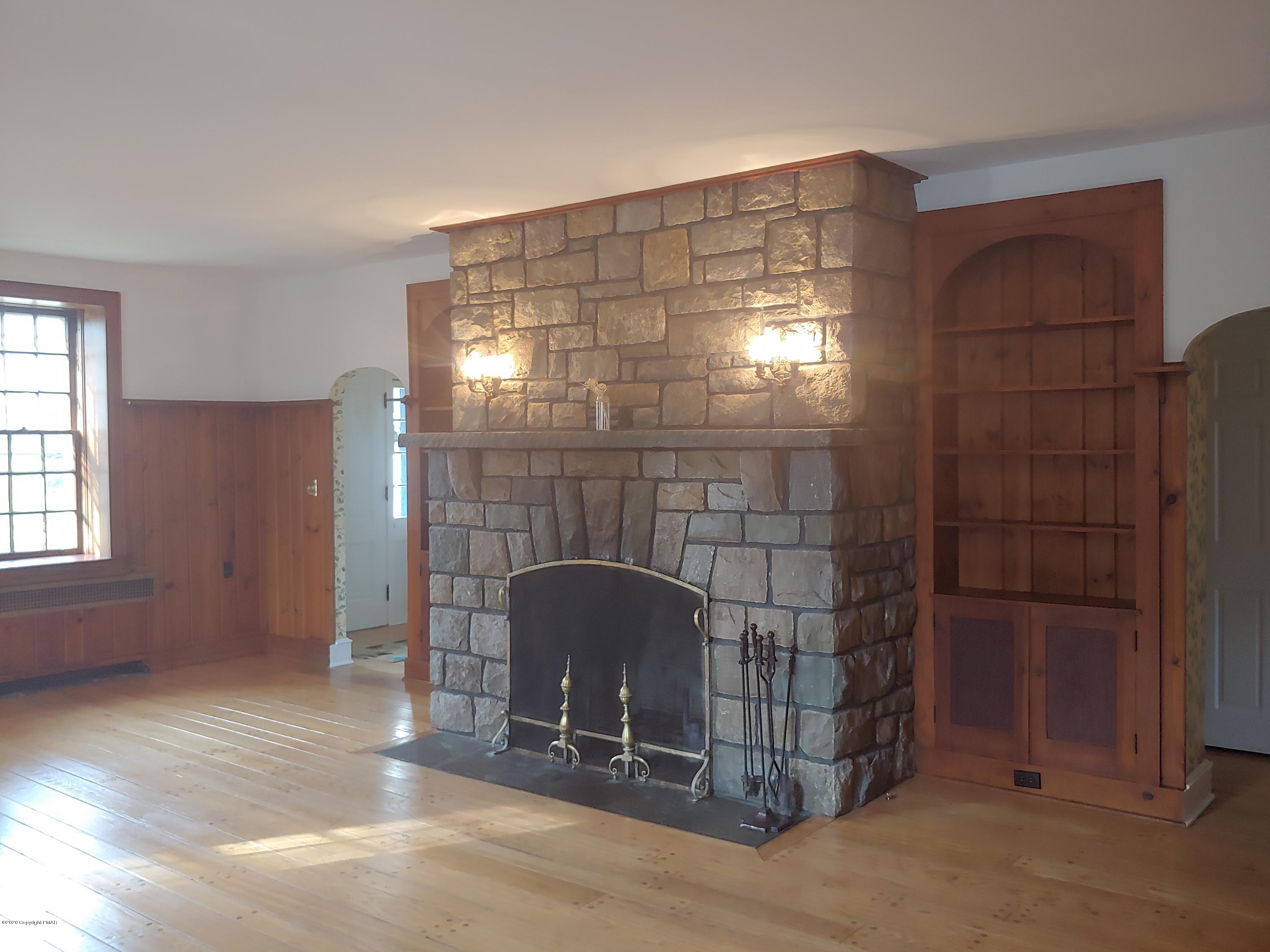 476 Laurel Pine Road Cresco, PA 18326 - Photo 6 of 45 a room with a glass door and chandelier fan