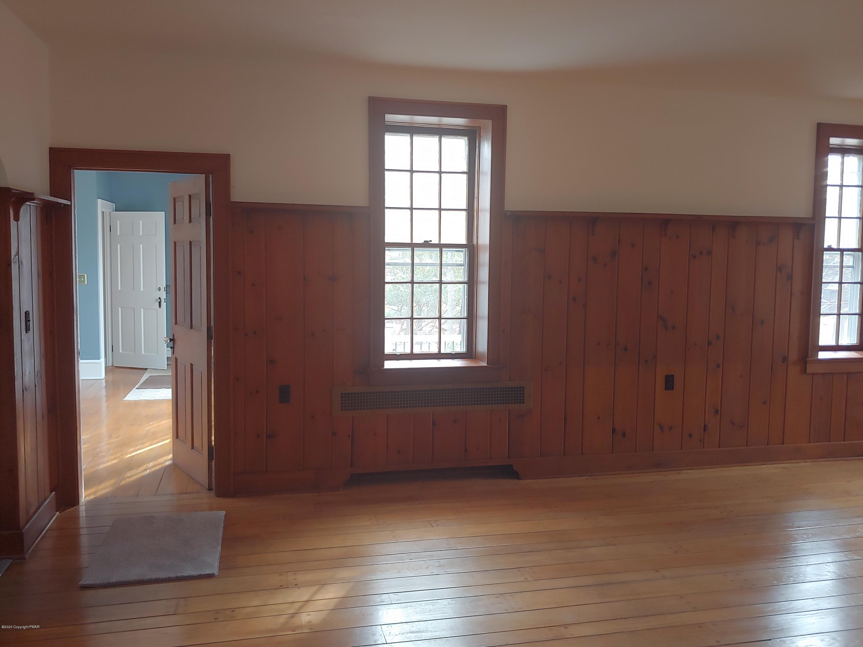 476 Laurel Pine Road Cresco, PA 18326 - Photo 9 of 45 an empty room with wooden floor and windows
