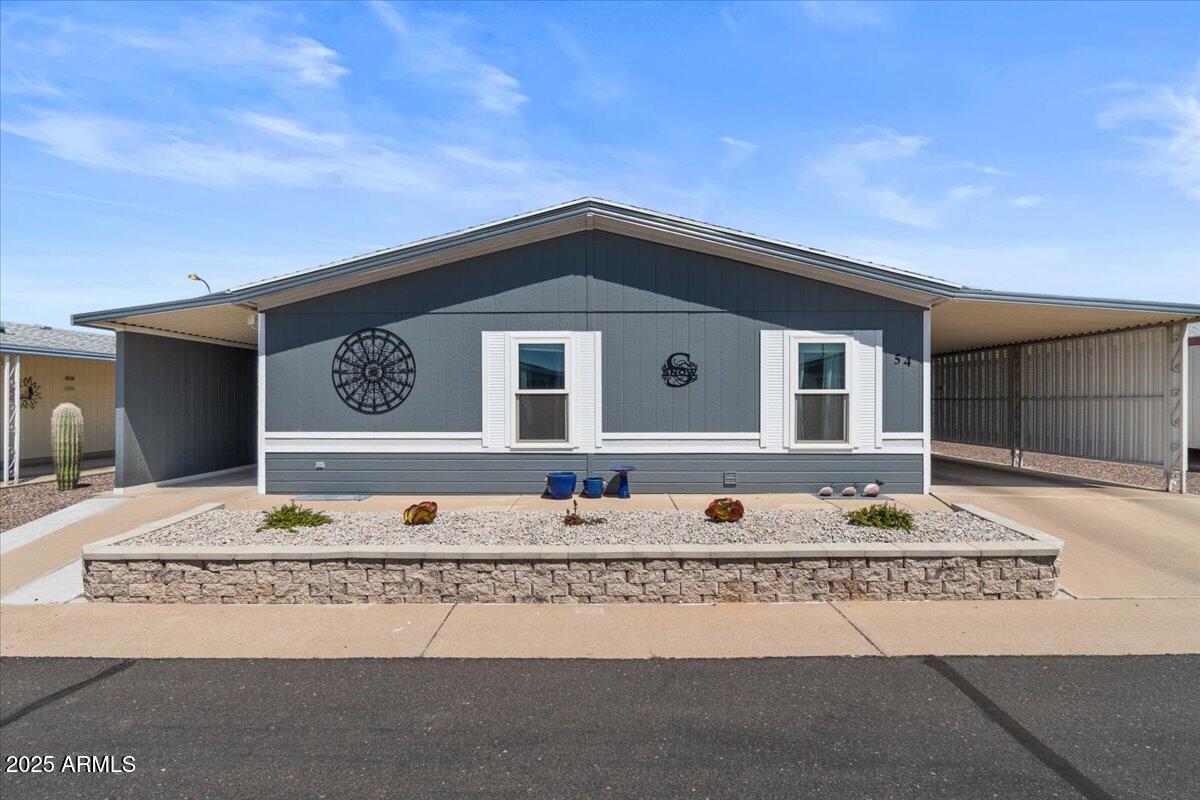 834 South Meridian Road, Unit 54 Apache Junction, AZ 85120 - Photo 1 of 56 a view of a wooden house with a large parking space