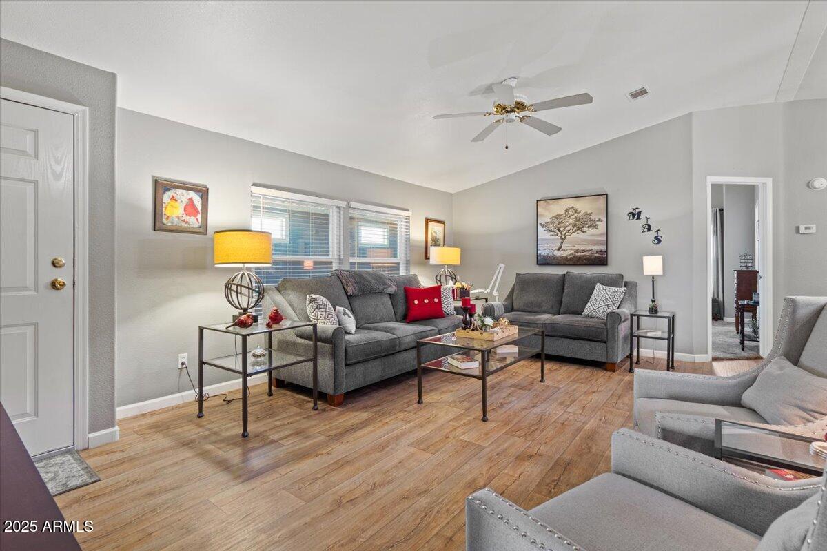 834 South Meridian Road, Unit 54 Apache Junction, AZ 85120 - Photo 11 of 56 a living room with furniture and a wooden floor