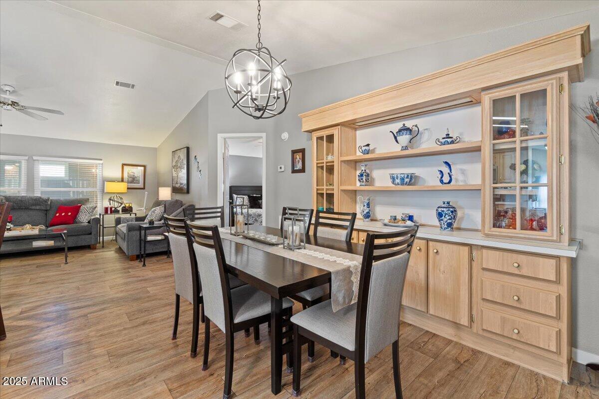 834 South Meridian Road, Unit 54 Apache Junction, AZ 85120 - Photo 15 of 56 a view of a dining room with furniture and wooden floor