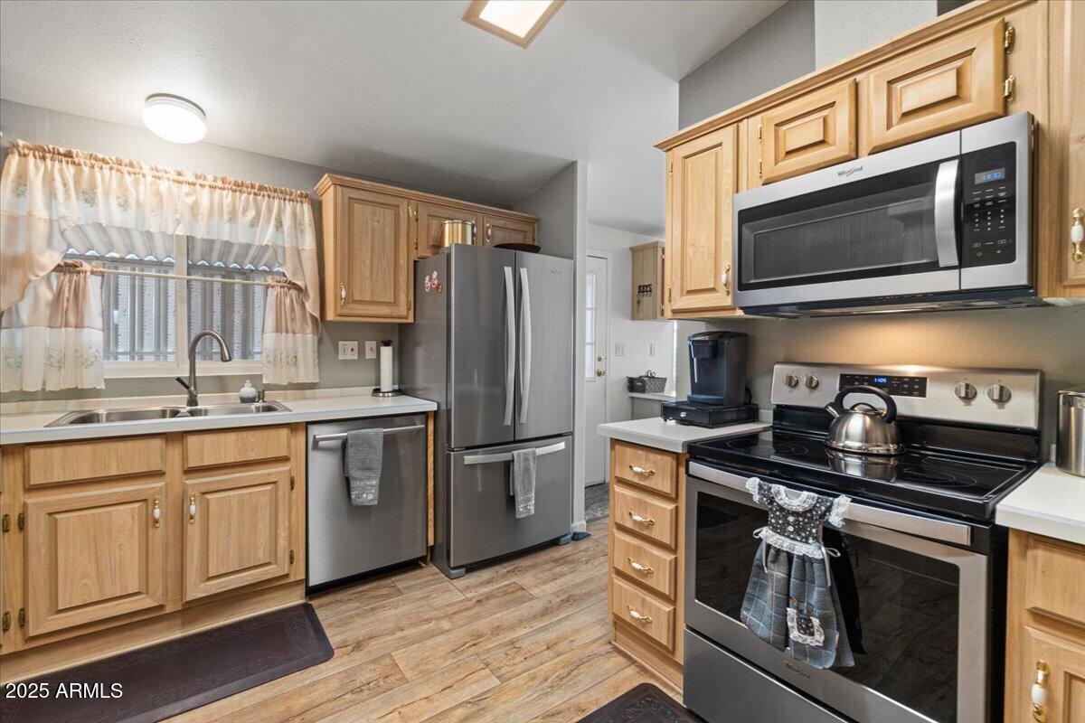 834 South Meridian Road, Unit 54 Apache Junction, AZ 85120 - Photo 19 of 56 a kitchen with stainless steel appliances granite countertop a stove a sink and a microwave
