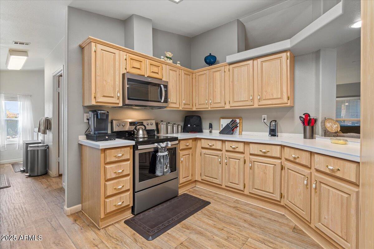 834 South Meridian Road, Unit 54 Apache Junction, AZ 85120 - Photo 20 of 56 a kitchen with cabinets stainless steel appliances and a window