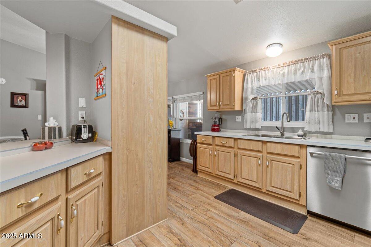 834 South Meridian Road, Unit 54 Apache Junction, AZ 85120 - Photo 21 of 56 a kitchen with granite countertop a sink stainless steel appliances and cabinets