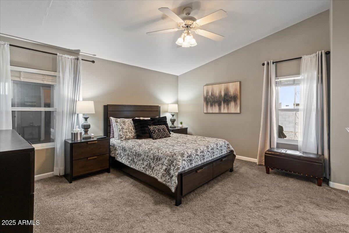 834 South Meridian Road, Unit 54 Apache Junction, AZ 85120 - Photo 24 of 56 a bedroom with a bed and a chandelier