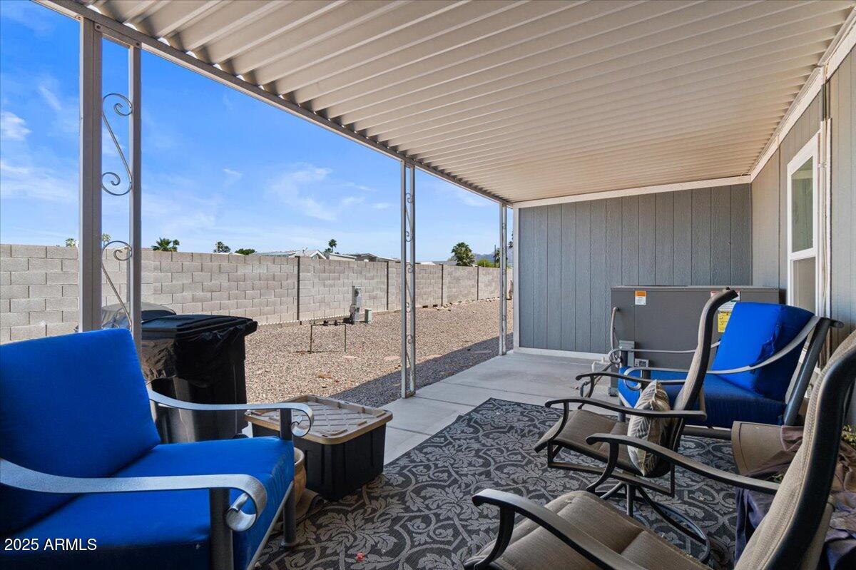 834 South Meridian Road, Unit 54 Apache Junction, AZ 85120 - Photo 37 of 56 a living room with furniture a flat screen tv and floor to ceiling window