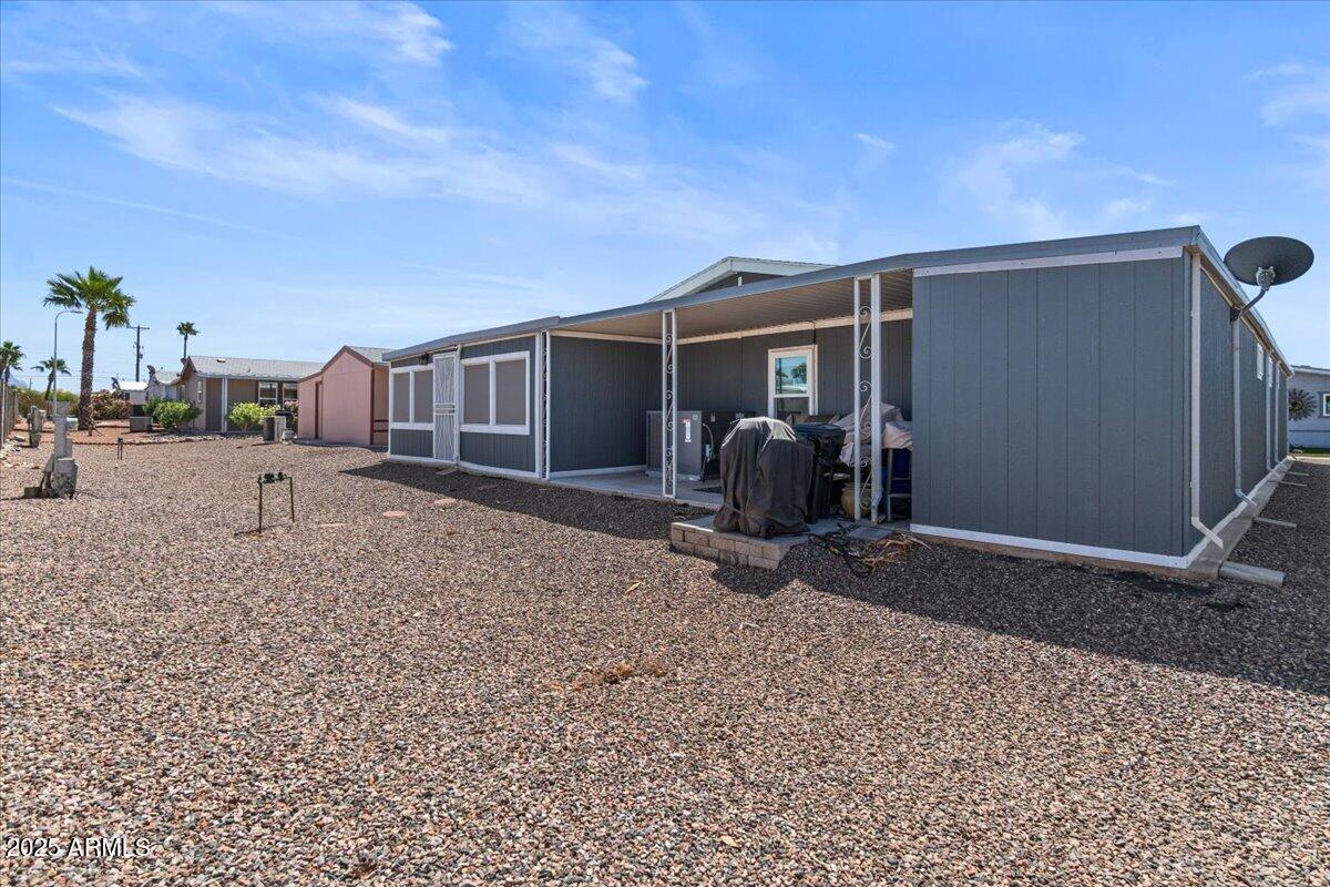 834 South Meridian Road, Unit 54 Apache Junction, AZ 85120 - Photo 40 of 56 a view of a house with backyard