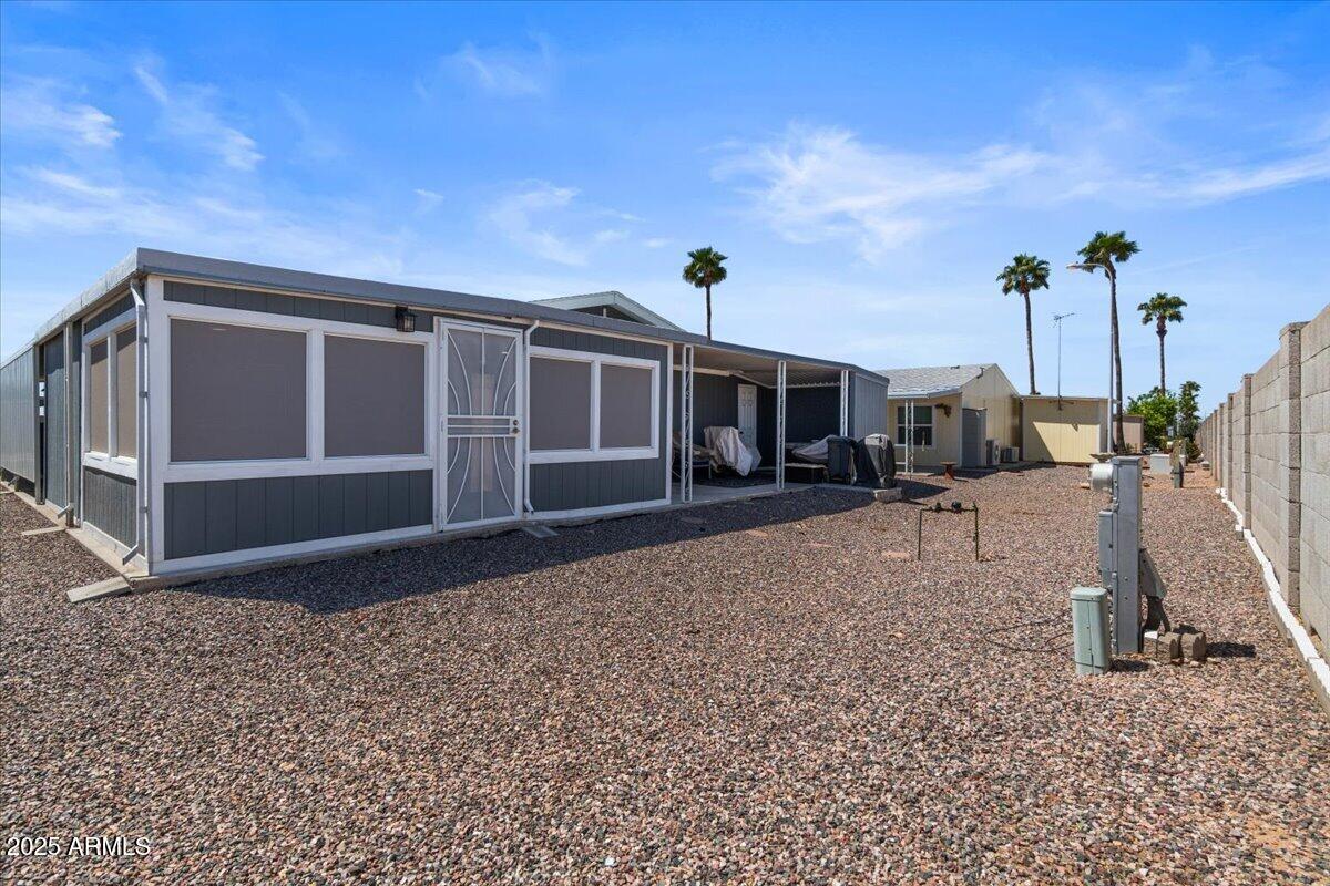 834 South Meridian Road, Unit 54 Apache Junction, AZ 85120 - Photo 41 of 56 a front view of a house with a yard