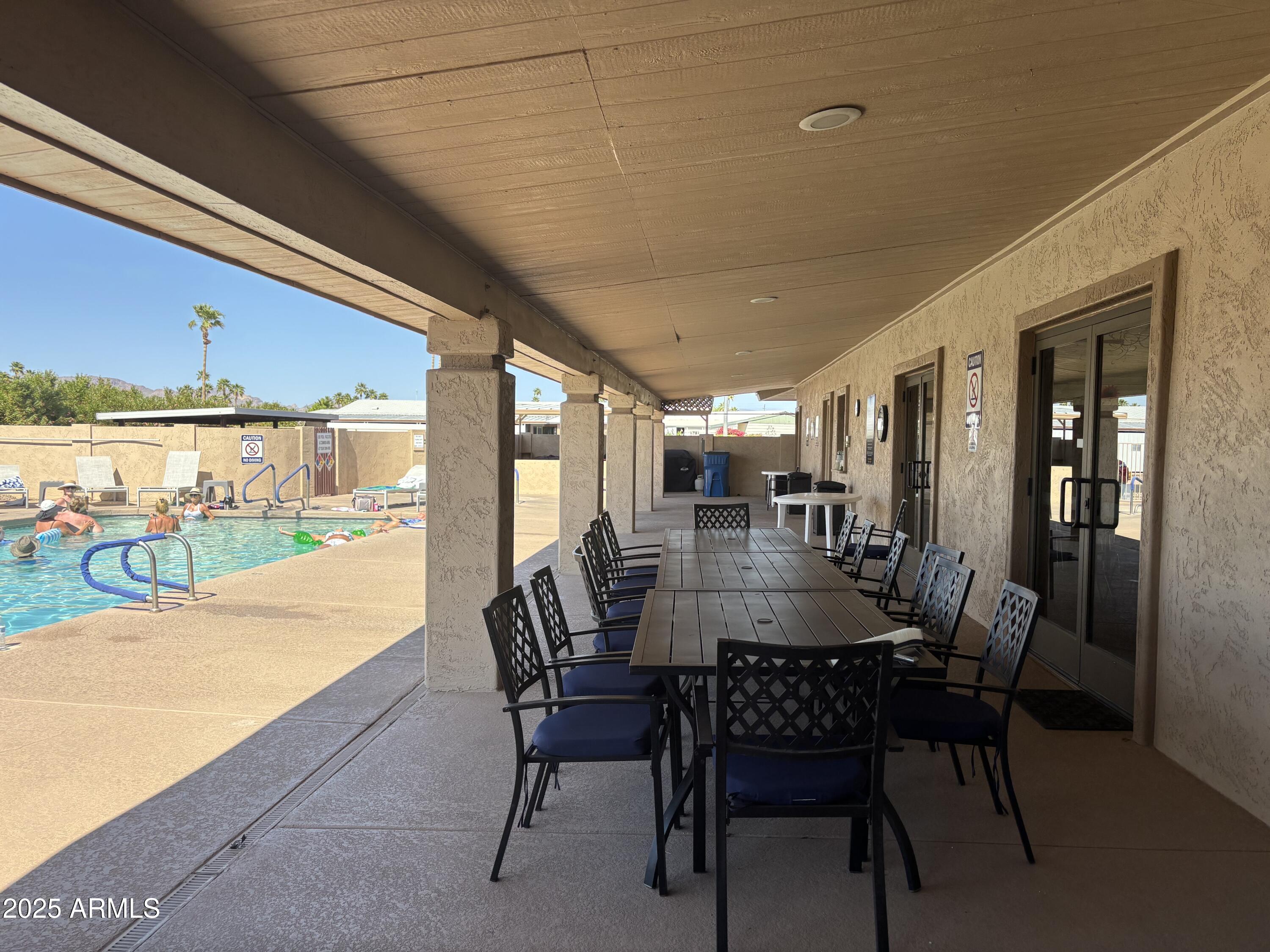 834 South Meridian Road, Unit 54 Apache Junction, AZ 85120 - Photo 53 of 56 a dining room with furniture and a floor to ceiling window