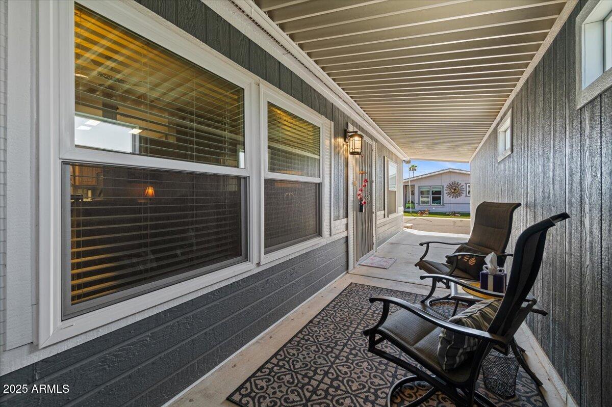 834 South Meridian Road, Unit 54 Apache Junction, AZ 85120 - Photo 6 of 56 a view of a balcony with chair and wooden floor