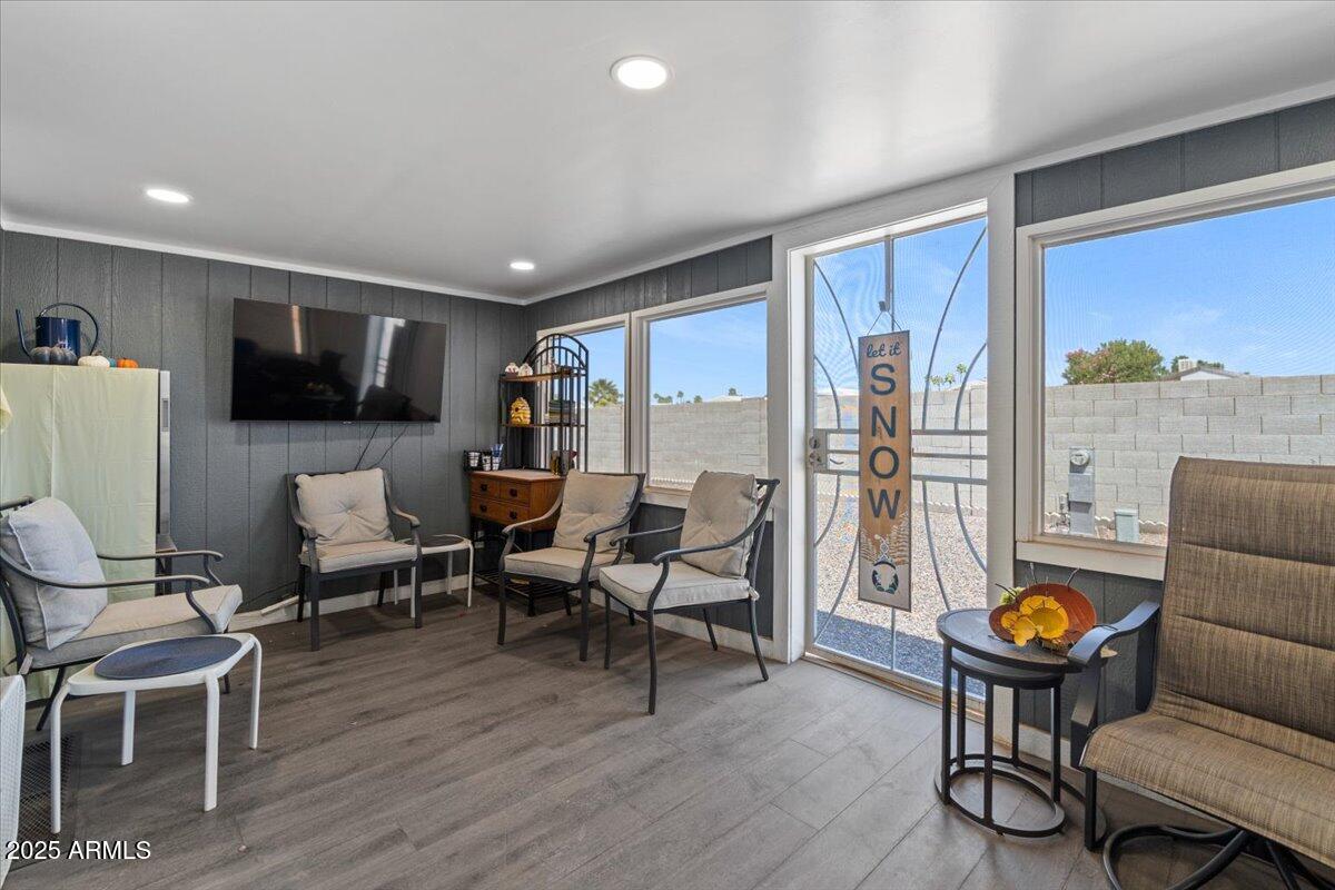 834 South Meridian Road, Unit 54 Apache Junction, AZ 85120 - Photo 8 of 56 a living room with furniture a flat screen tv and a floor to ceiling window