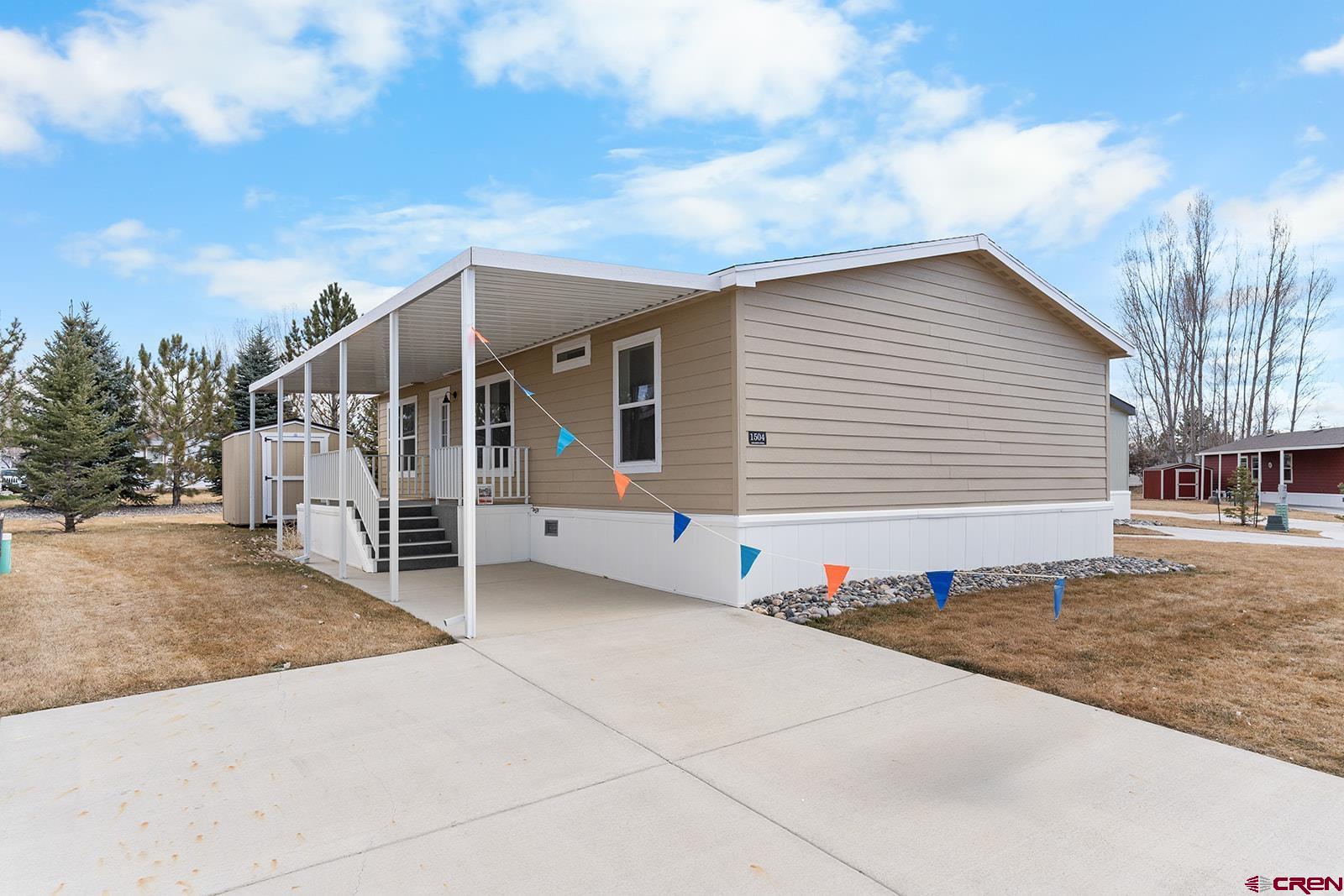 901 6530 Road, Unit 1504 Montrose, CO 81401 - Photo 1 of 25 a view of house with stairs and wooden fence