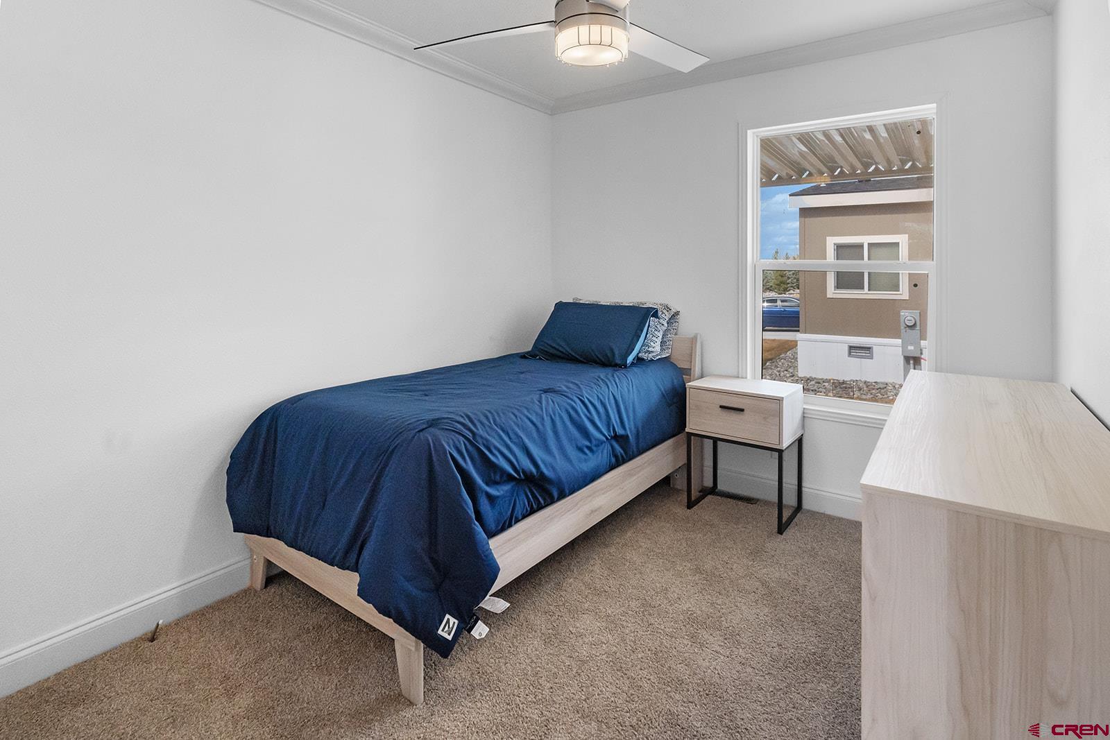 901 6530 Road, Unit 1504 Montrose, CO 81401 - Photo 12 of 25 a bedroom with a bed and a lamp on table