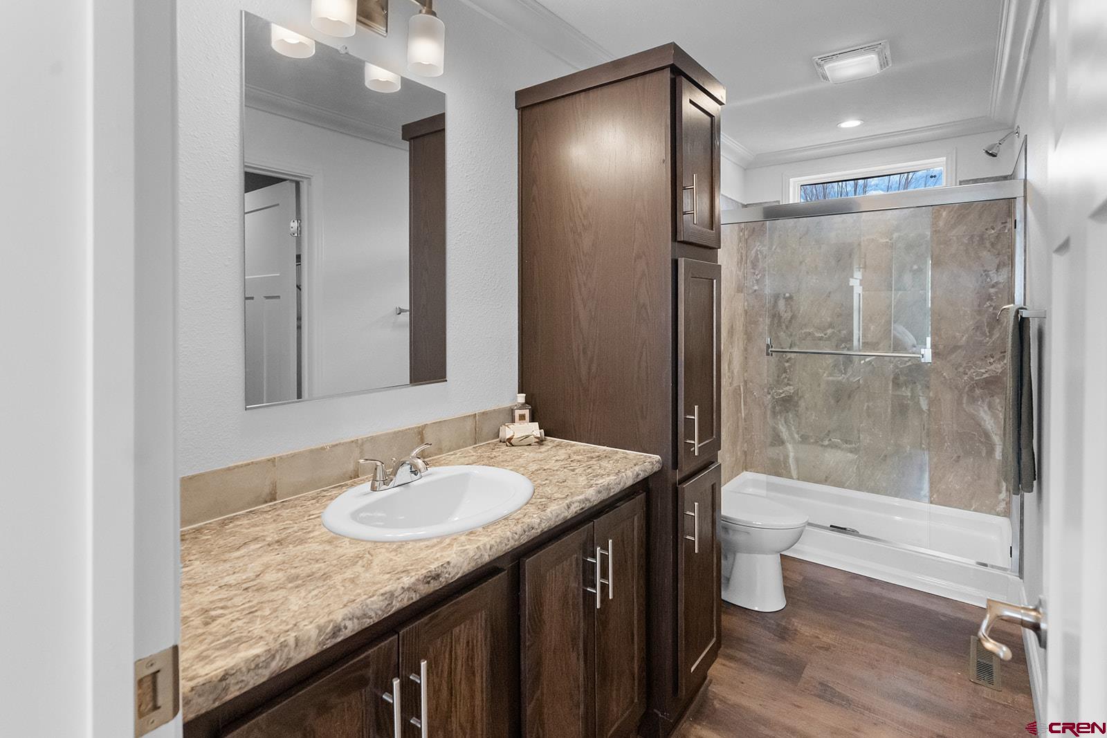 901 6530 Road, Unit 1504 Montrose, CO 81401 - Photo 18 of 25 a bathroom with a granite countertop sink toilet and shower