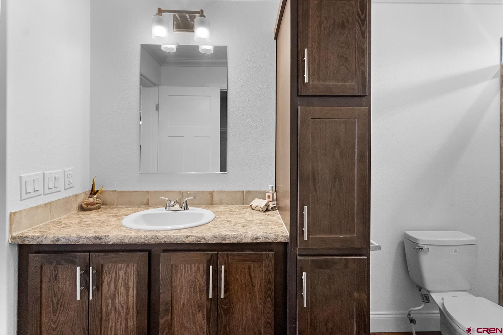901 6530 Road, Unit 1504 Montrose, CO 81401 - Photo 19 of 25 a bathroom with a granite countertop sink and a mirror