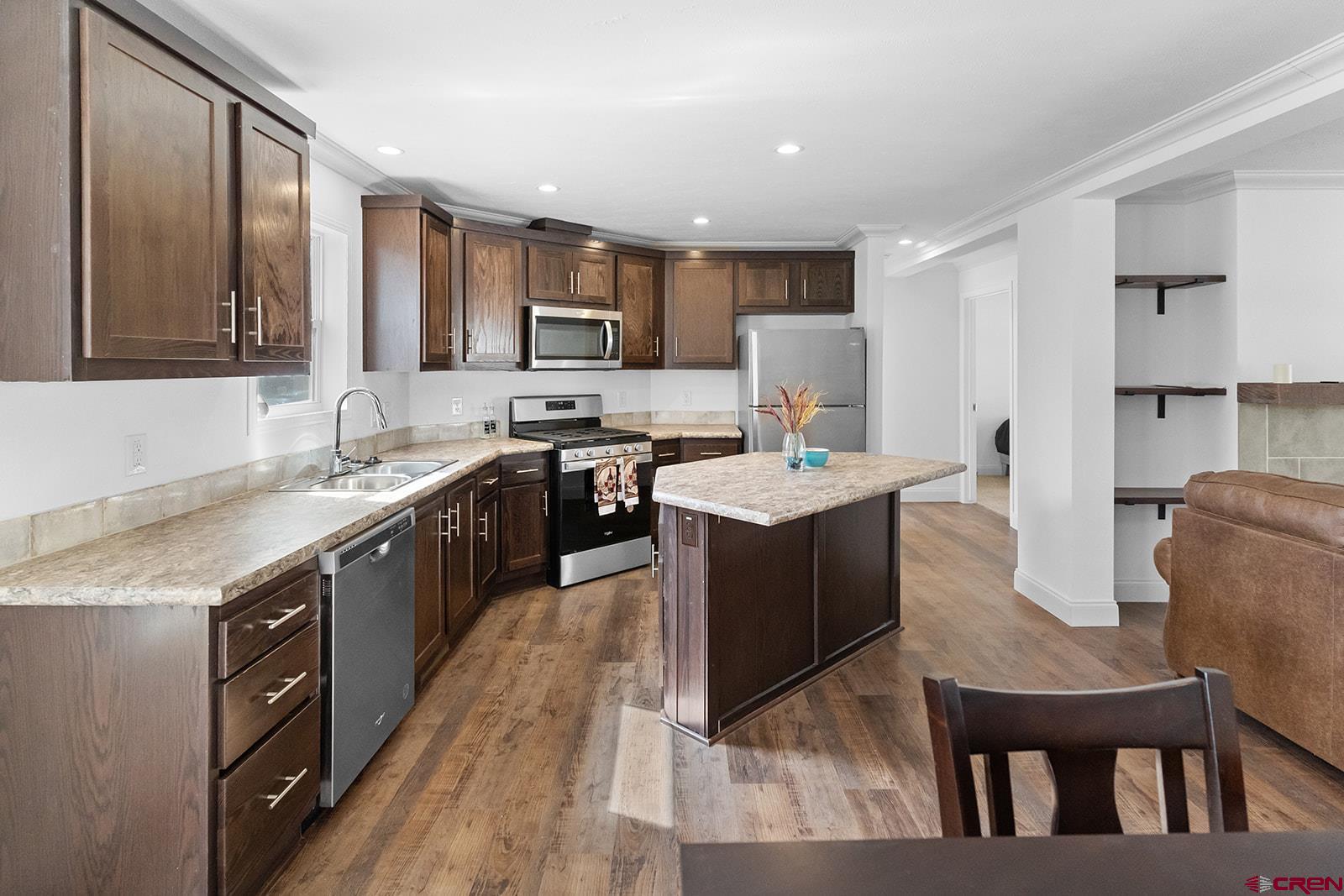 901 6530 Road, Unit 1504 Montrose, CO 81401 - Photo 8 of 25 a large kitchen with stainless steel appliances lots of counter top space a sink dishwasher and cabinets