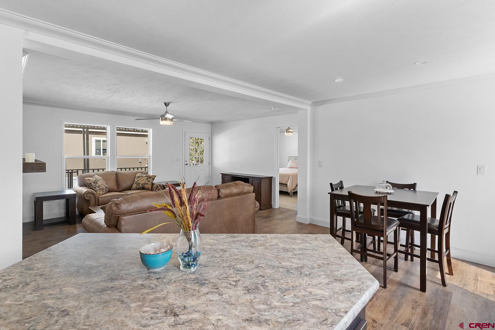 901 6530 Road, Unit 1504 Montrose, CO 81401 - Photo 9 of 25 a living room with furniture a wooden floor and a potted plant