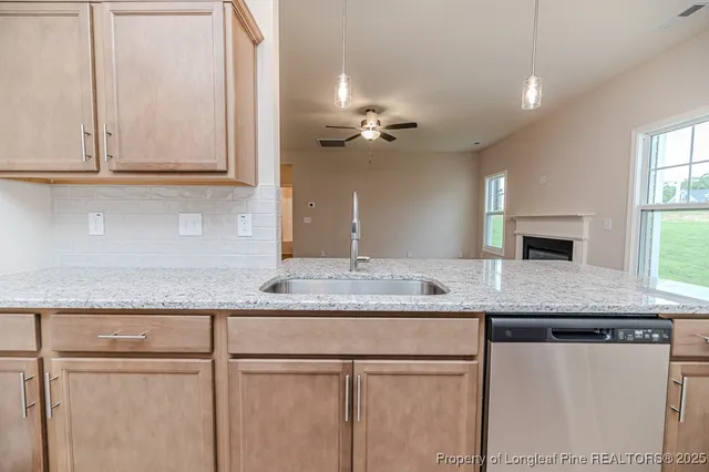 a kitchen with granite countertop cabinets and window