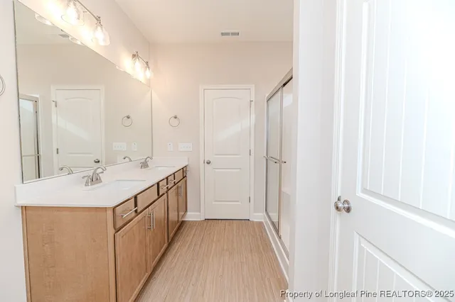 a bathroom with a double vanity sink and mirror