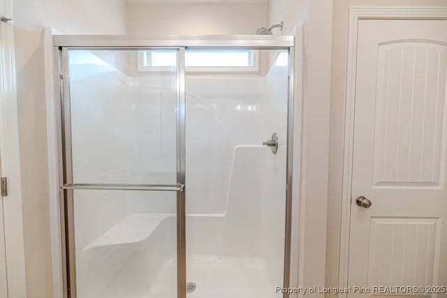 a bathroom with a glass shower door